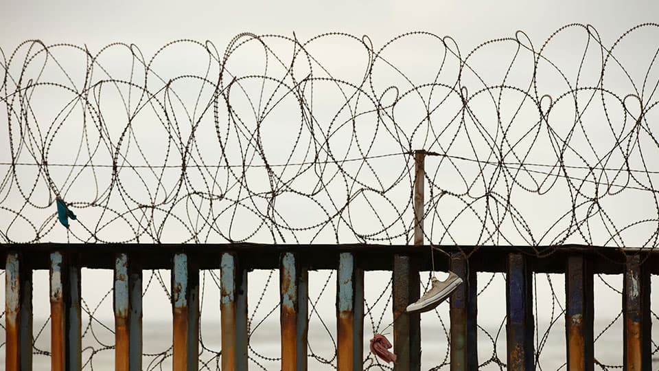 Barbed wire on the top of a fence
