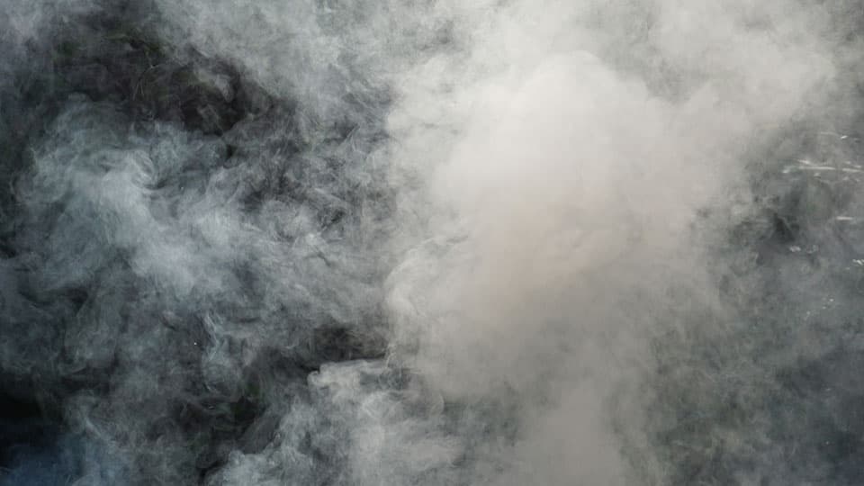 Plume of white smoke with a black background