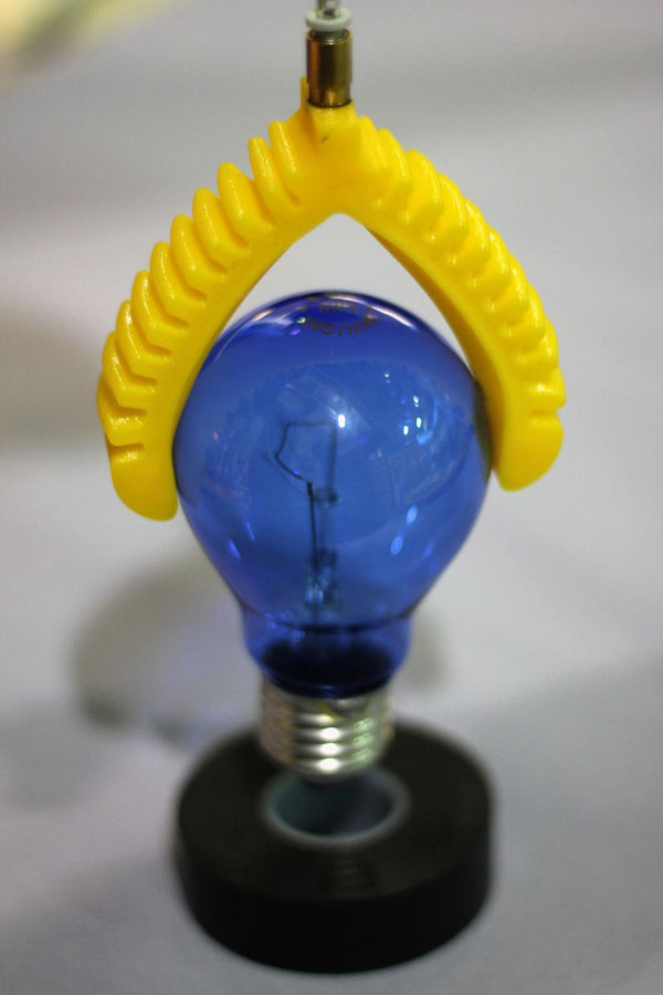 3D printed soft gripper lifting a lightbulb