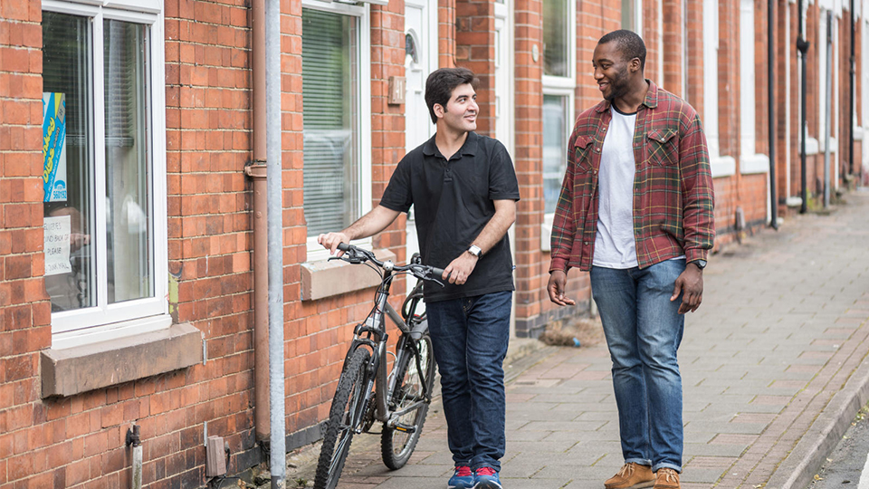 photo of two students walking outside student accommodation off-campus