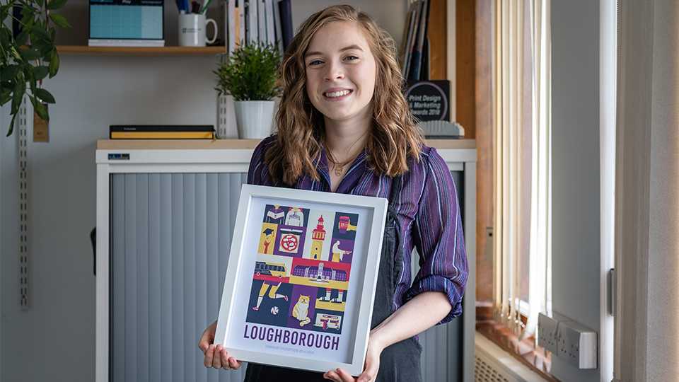 Photo of Lauren holding her printed illustration in a frame