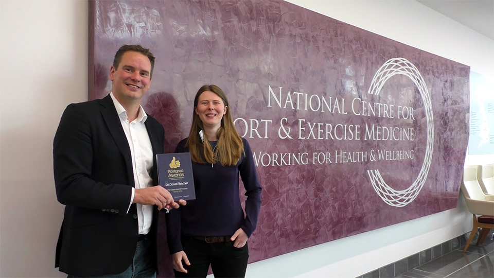 Photo of David Fletcher with his PhD Supervisor of the Year award trophy