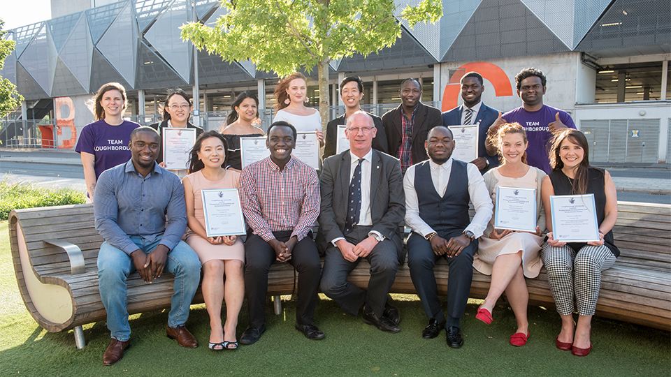 Photo of previous Inspiring Success attendees sat/stood with the Vice Chancellor