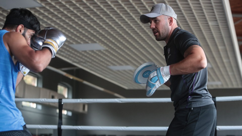 Angel Fernandez coaches a boxer 