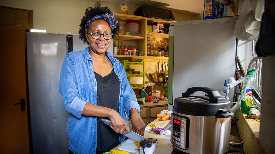 Photo of a woman smiling at the camera was prepping for cooking food