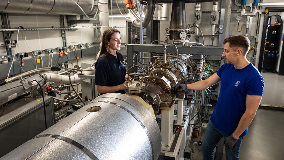 Photo of two engineers working inside Loughborough's world-class facilities 