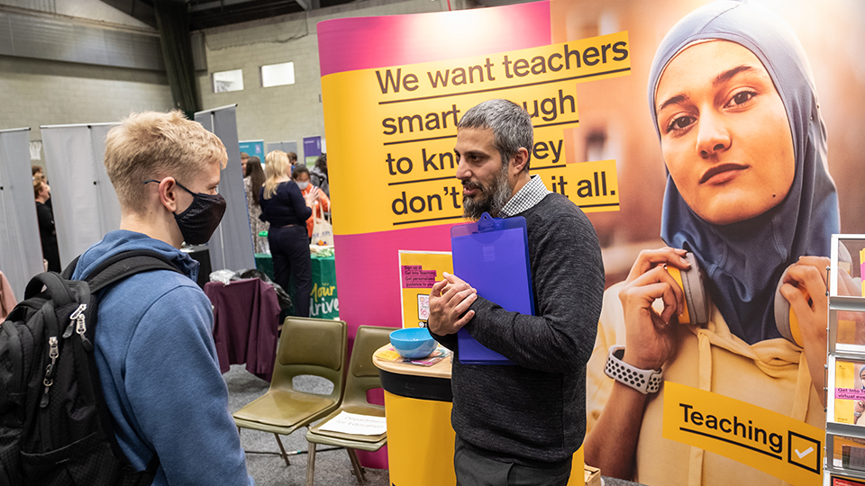 Photo of student talking to representative from Get Into Teaching at the Autumn Careers Fair 2021