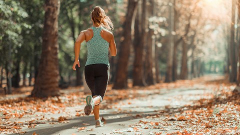 A woman jogging in the forest. 