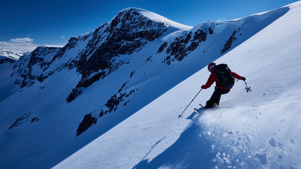 a snowy mountain with a skier