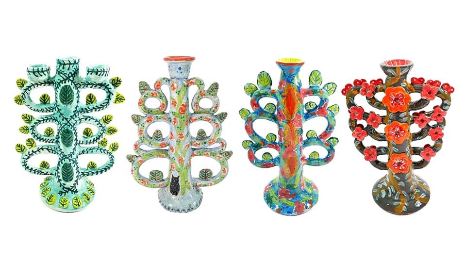 Row of four Tree of Life ceramic vases, decorated with natural patterns and colours.