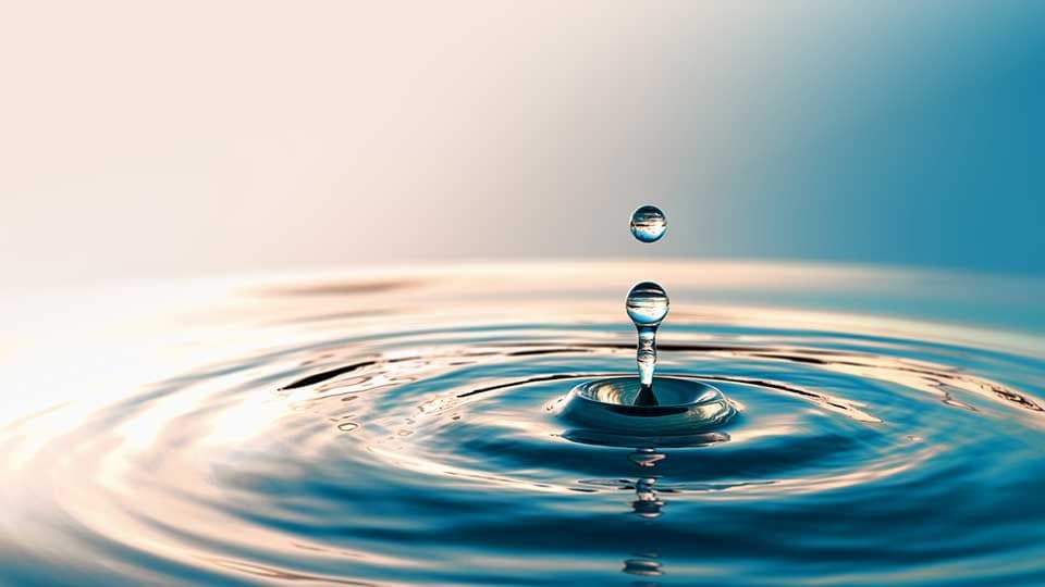 Droplets splashing into pool of water