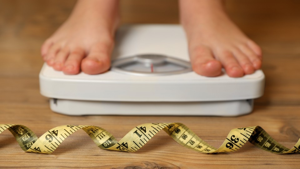 An image of a human on some weighing scales 