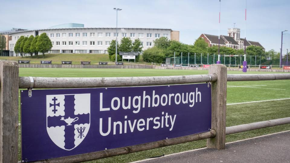 Loughborough university's logo on a board seen in front of the main rugby pitch on campus 