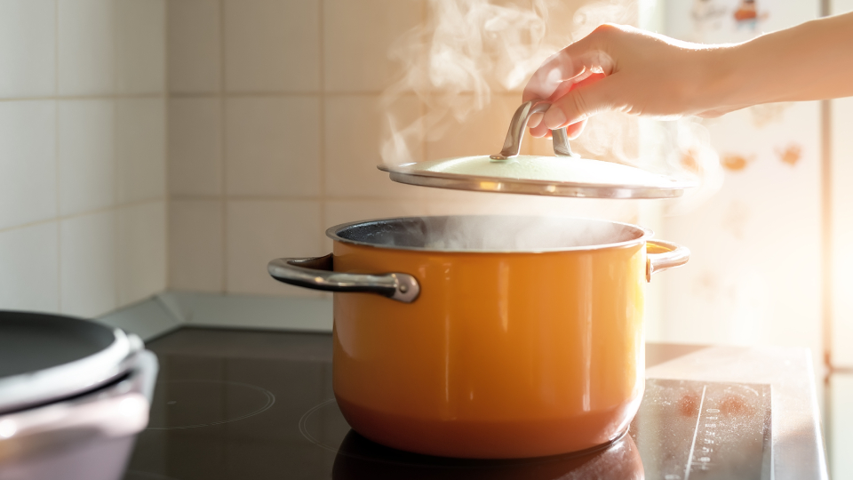 A pan of steaming food on the hob