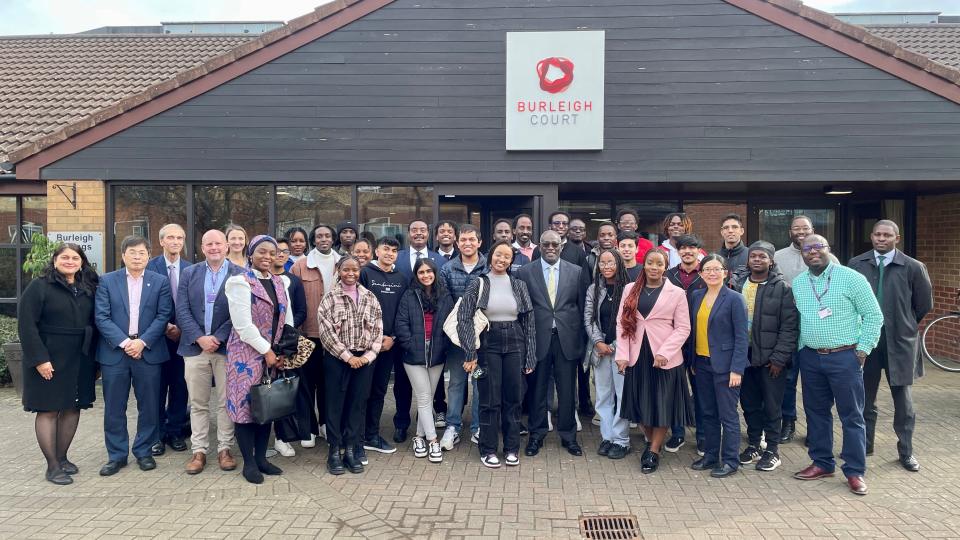 Photo of High Commissioner of Kenya delegation stood with Kenyan students at the University and some colleagues in front of the Burleigh Court Hotel