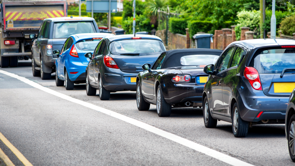 A row of cars in a traffic jam on a UK road