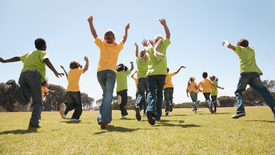 a group of children running away together playing sport