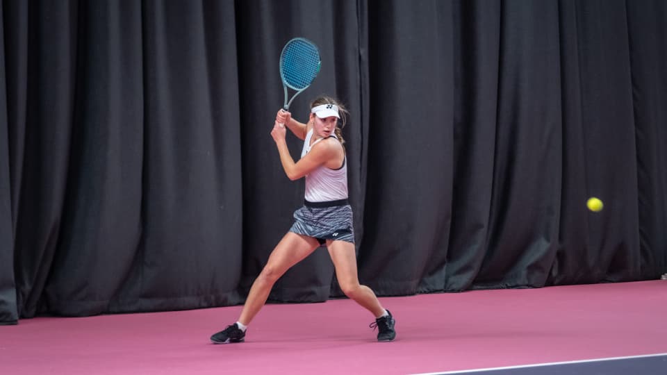 A woman playing a tennis shot