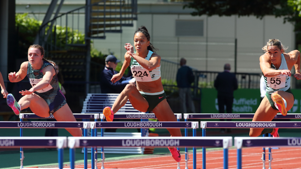 Athlete Katarina Johnson-Thompson jumps over a hurdle during a race