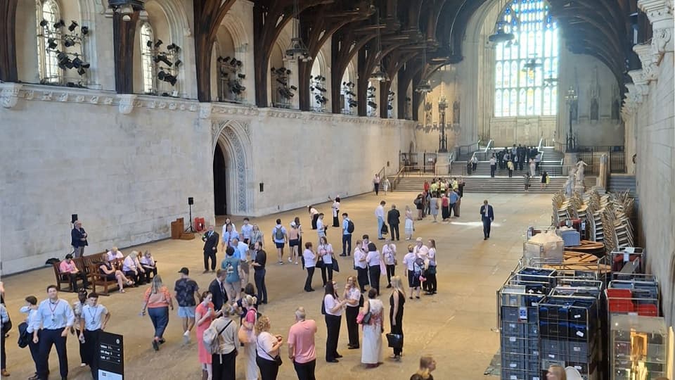 People walking around a large, church-like room at Evidence Week