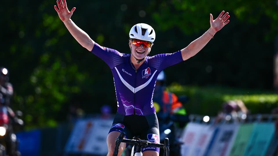 Lily Martin crossing the finish line on bike
