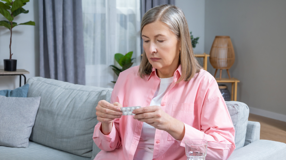 a woman looking a pill packet