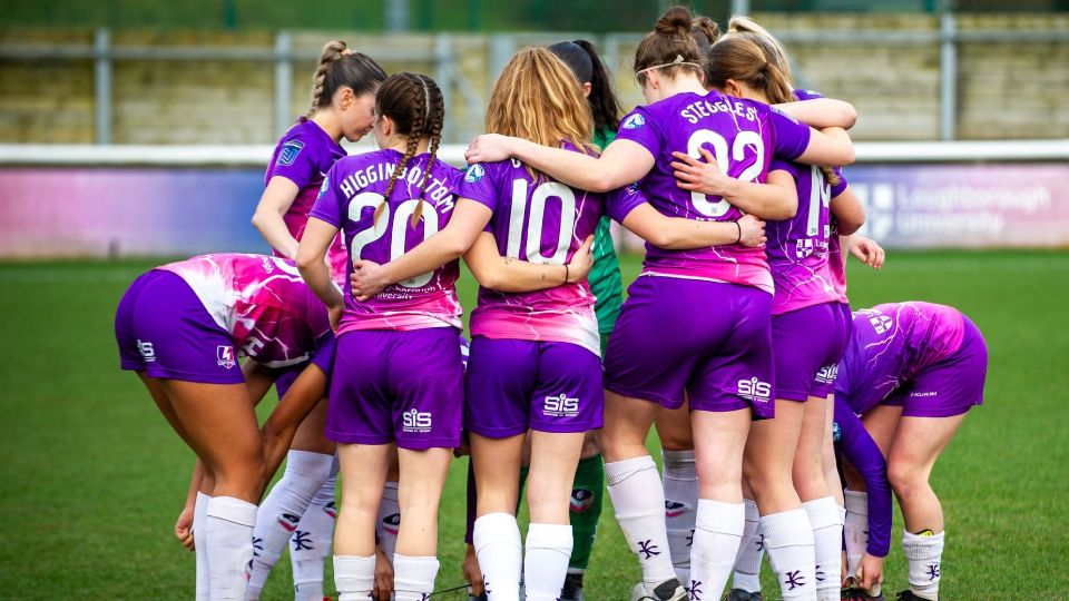 football players in a huddle