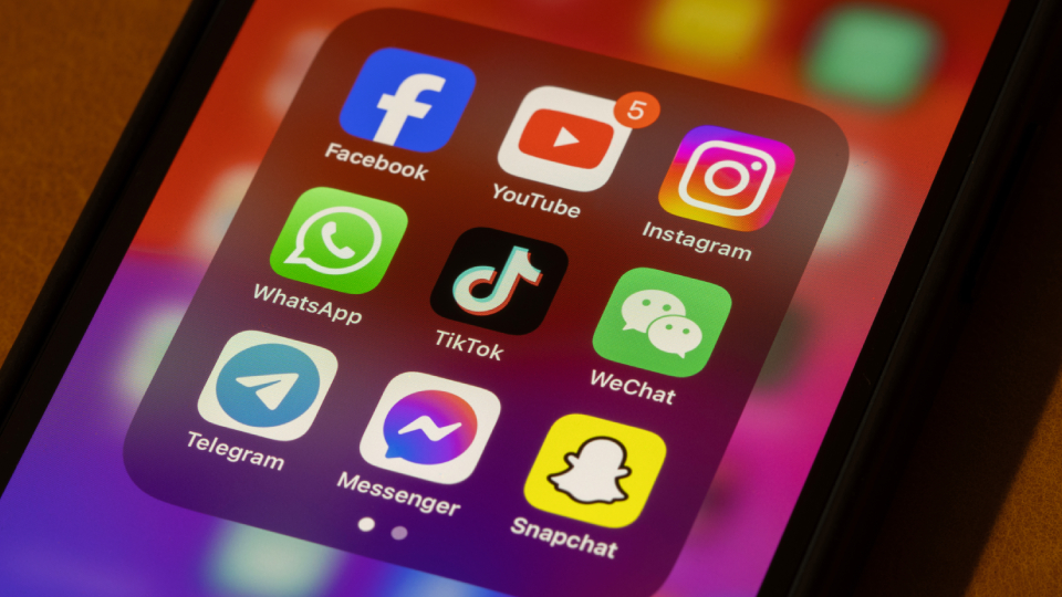 social media icons displayed on a phone