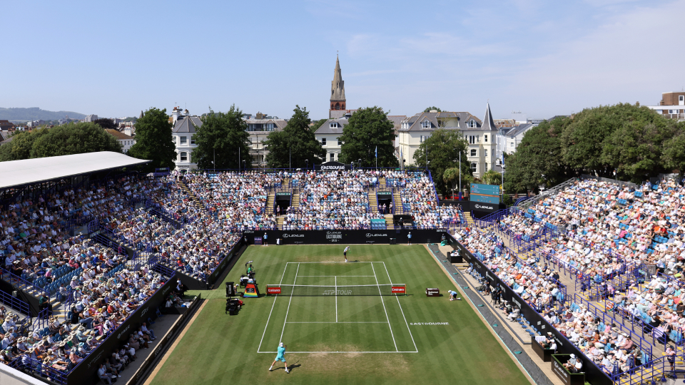 an aerial shot of a tennis match over a stadium