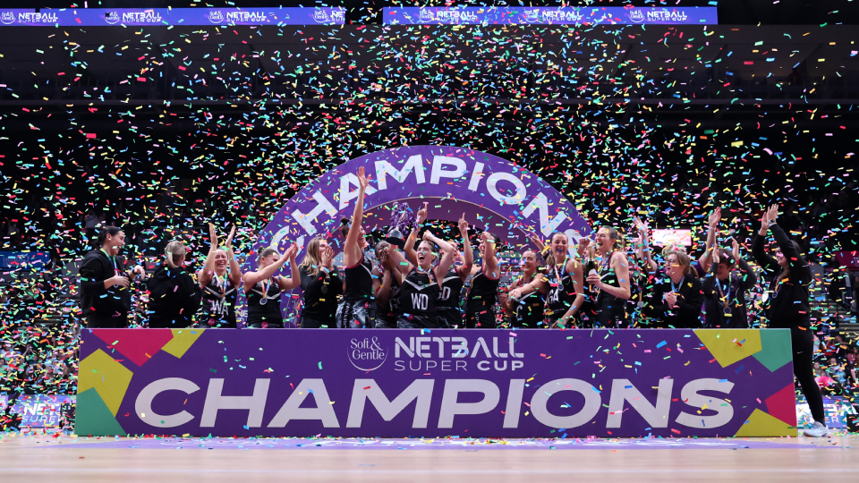 lighting netball lift the super cup trophy