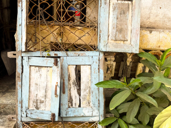 Distressed window shutters outside a home.