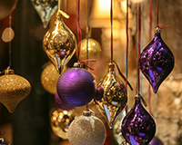 image of purple and gold Christmas baubles hanging