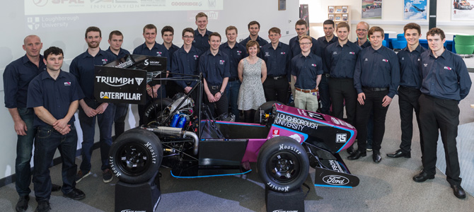 Students standing around a Formula Student racing car