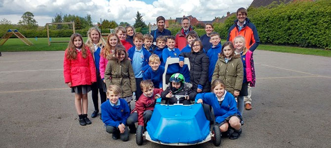 Group of people from Aston on Trent Primary School and the department with the car