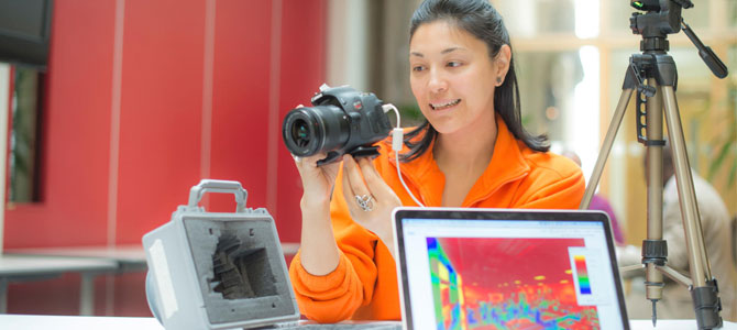 Research student demonstrating use of a thermal imaging camera