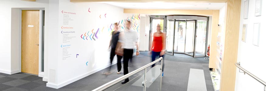 Image of students walking along the entrance atrium of Bridgeman Building, home to the Careers Network.