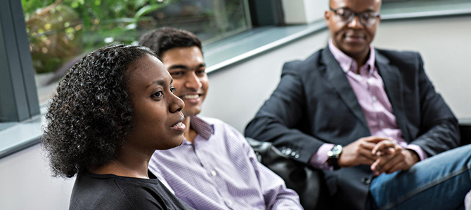 Three staff members talking