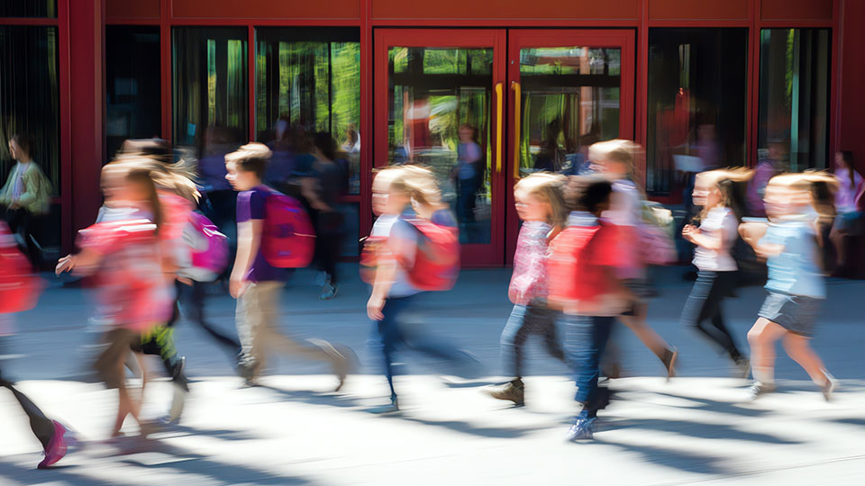 Blurred action shot of children running.