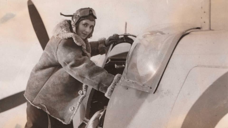 A pilot in the 1940s entering the cockpit of a Spitfire