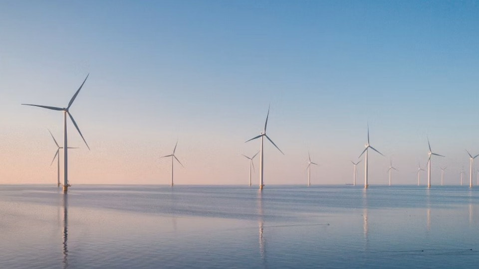 Wind turbines in the sea during sunrise