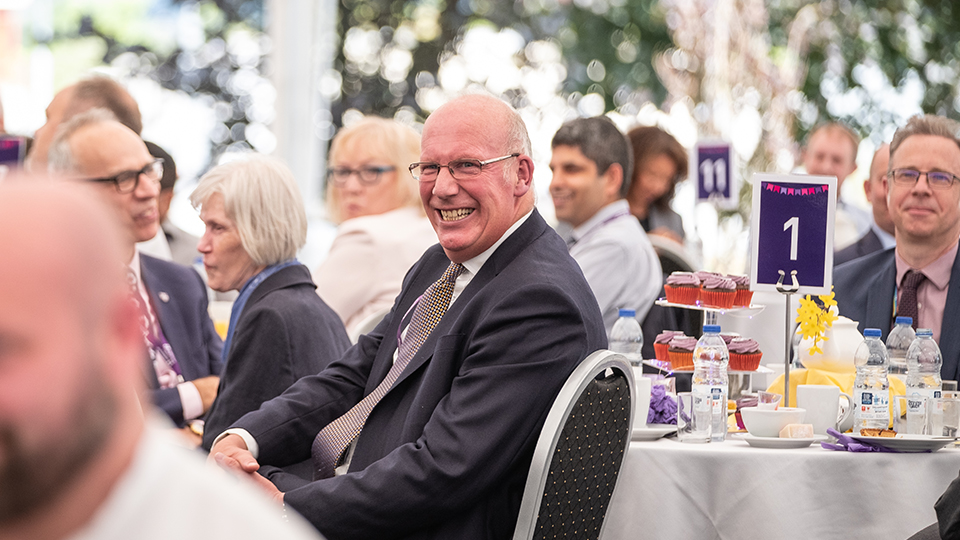 Photo of VC Bob laughing at his afternoon tea event in the marquee