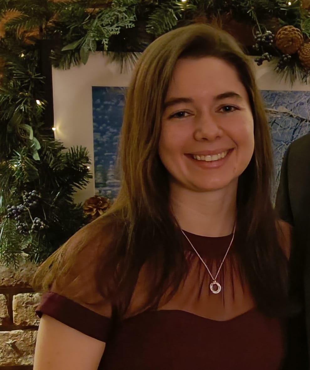 Headshot of current student Georgia Collis, who is smiling and looking at the camera