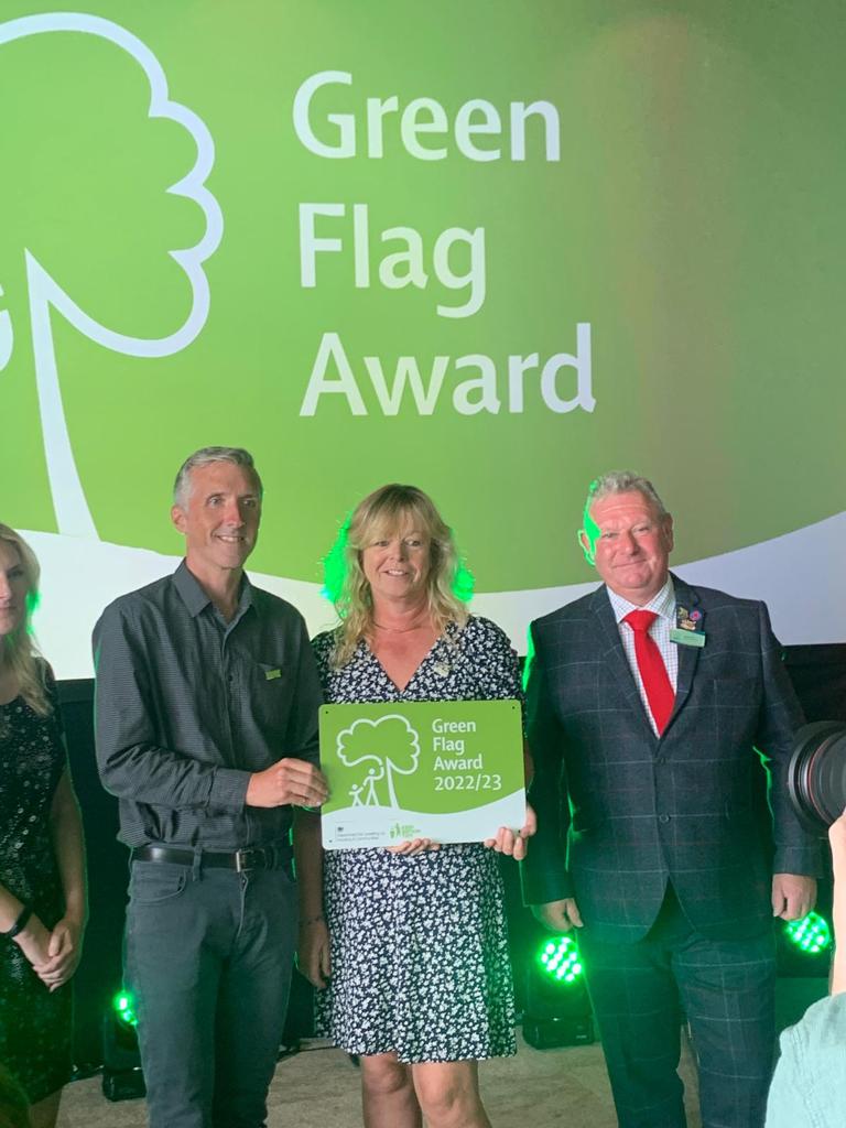 Photo of Rachel Senior Assistant Gardens Manager collecting the University's Green Flag Award 