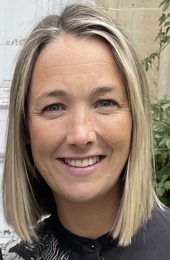 Headshot of Lily Rumsey, who is smiling towards the camera 