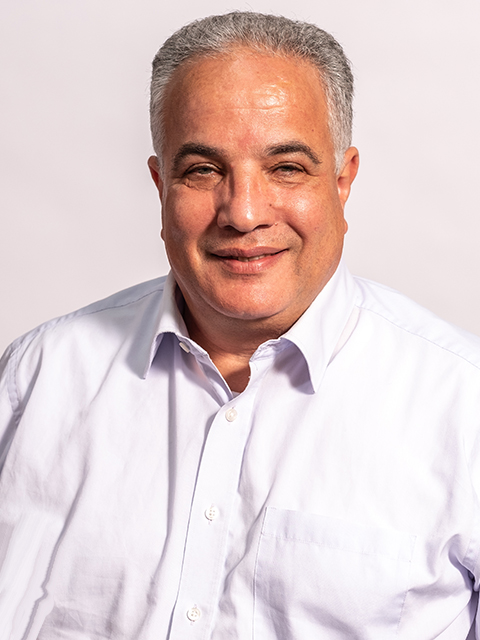 Headshot of Professor Osmani, who is facing the camera smiling and wearing a white shirt