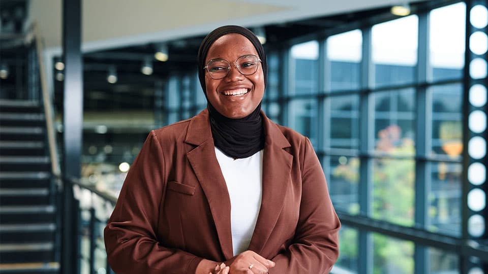 Mubeenat Adamu smiling in an office building