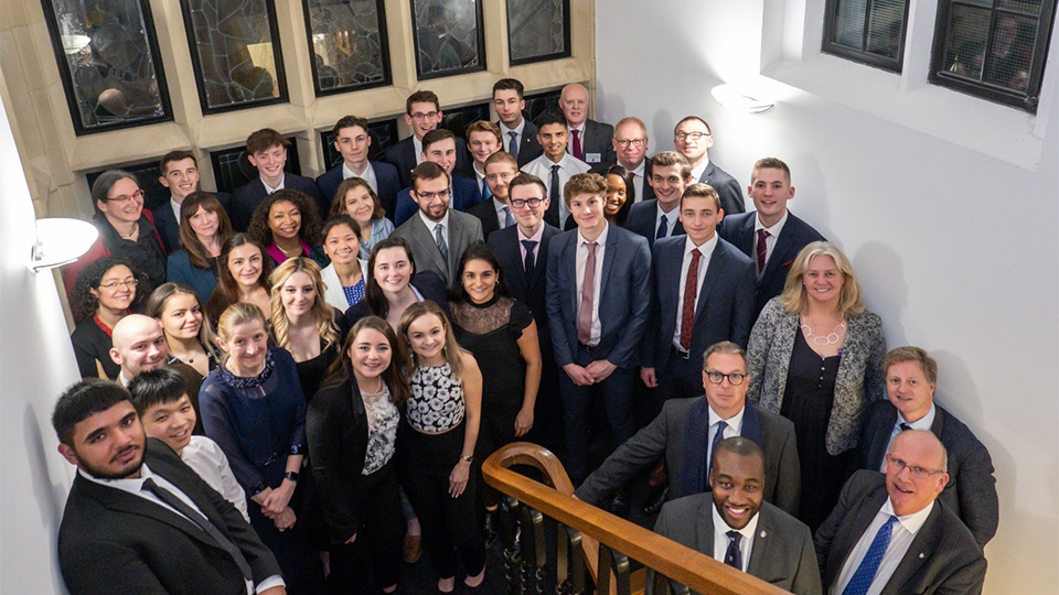Photo of student recipients and staff members on the Hazlerigg staircase