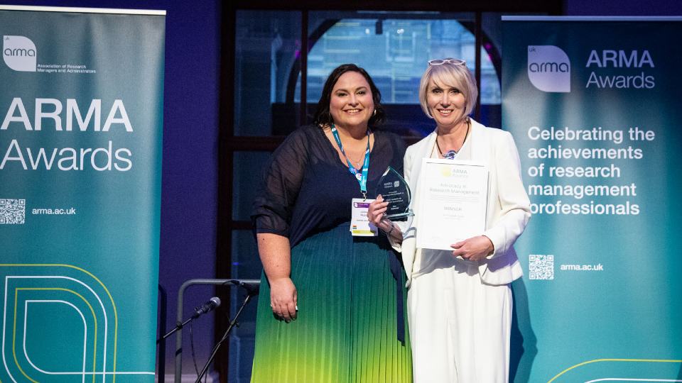 Lizzie Gadd holding her award with two colleagues at the ARMA Awards