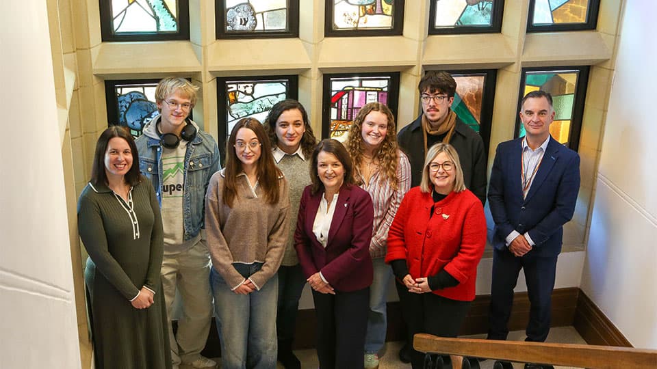 A group of arts and music scholars stood with LU Arts representatives