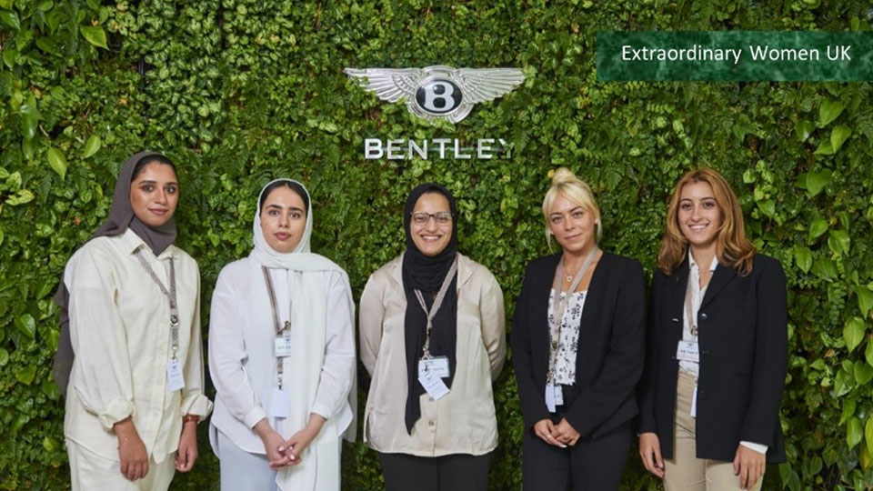 Five women in front of Bentley logo